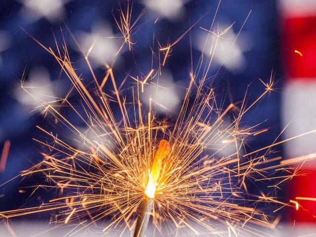 A firework in front of an american flag
