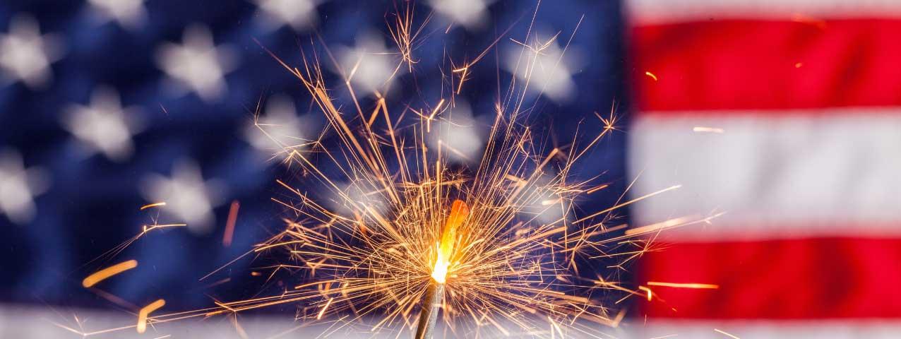 A firework in front of an american flag