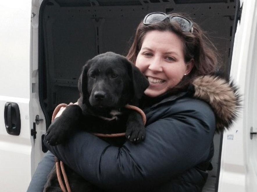 Ali Porter holding a puppy off transport
