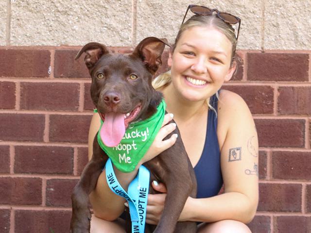 Aly Getz, Driver, Handler, Foster, and Dogs Day Out Volunteer with a rescue dog