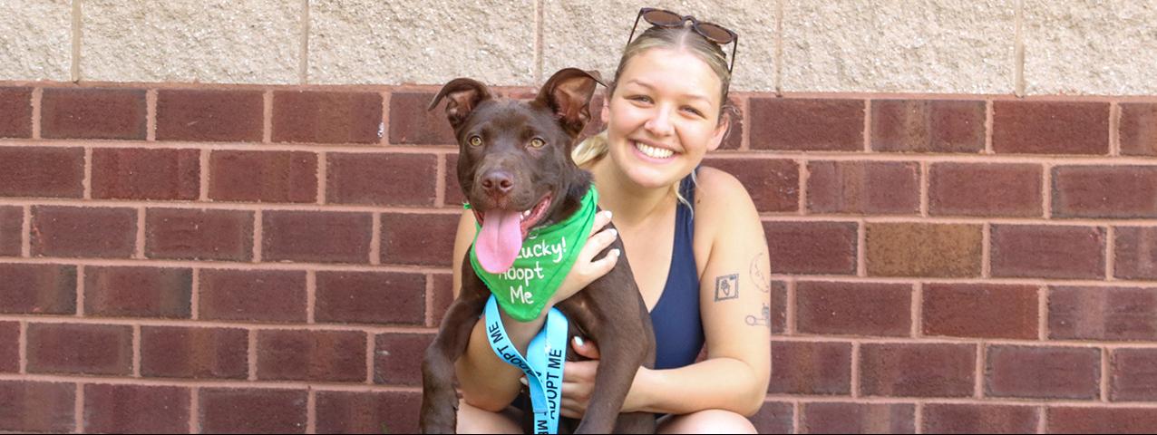Aly Getz, Driver, Handler, Foster, and Dogs Day Out Volunteer with a rescue dog