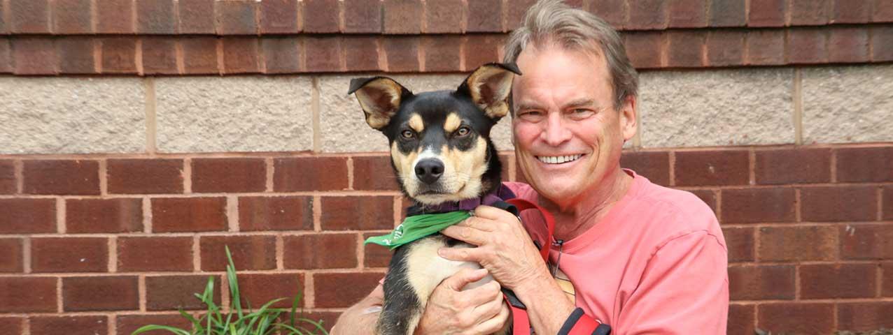 Chip Reid, Lucky Dog Animal Rescue Volunteer with a rescue dog
