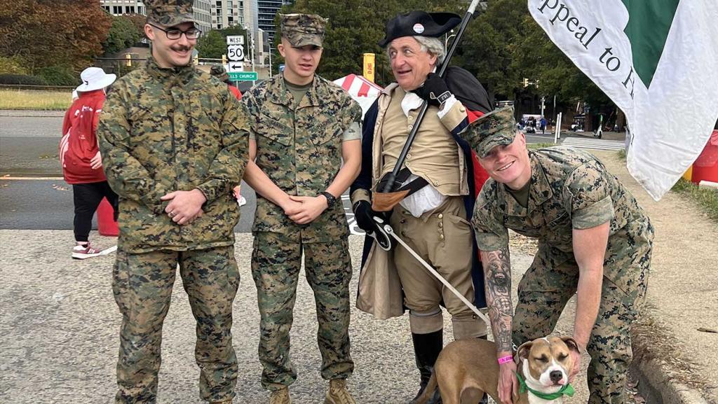 Men in uniform standing with a dog