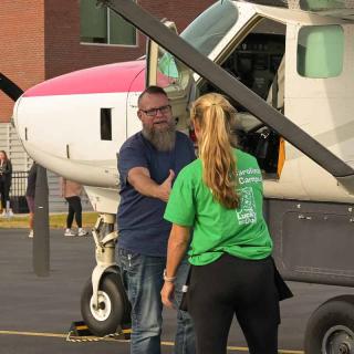 Mirah Horowitz welcoming Captain Wojo to the airport