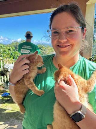 Lindsey Cope holding two stray kittens